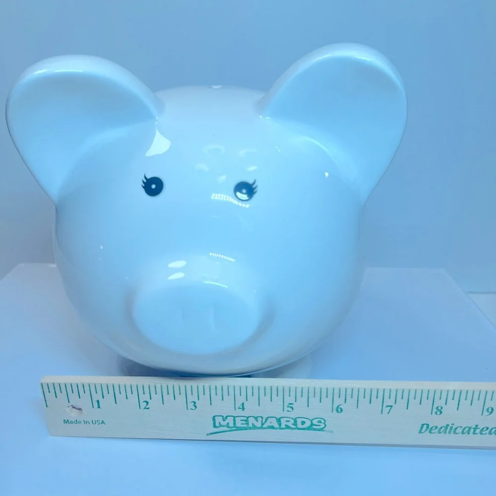 White Ceramic Piggy Bank with Pink and Purple Floral and Butterfly Designs.